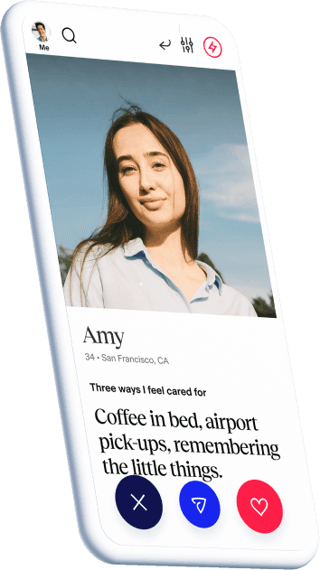 A phone displaying the dating profile of Amy, 34 years, from California. She feels cared for by things like coffee in bed, airport pick-ups and remembering the little things.